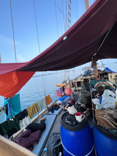 Morning tranquillity on Four Friends – some still peacefully asleep on the deck beneath the rising sun