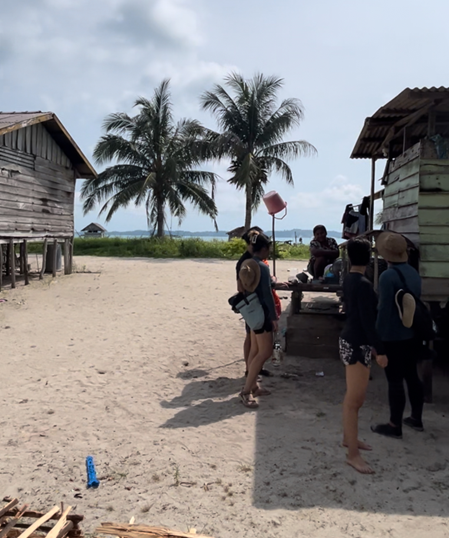 Conversing with a local by a wooden house